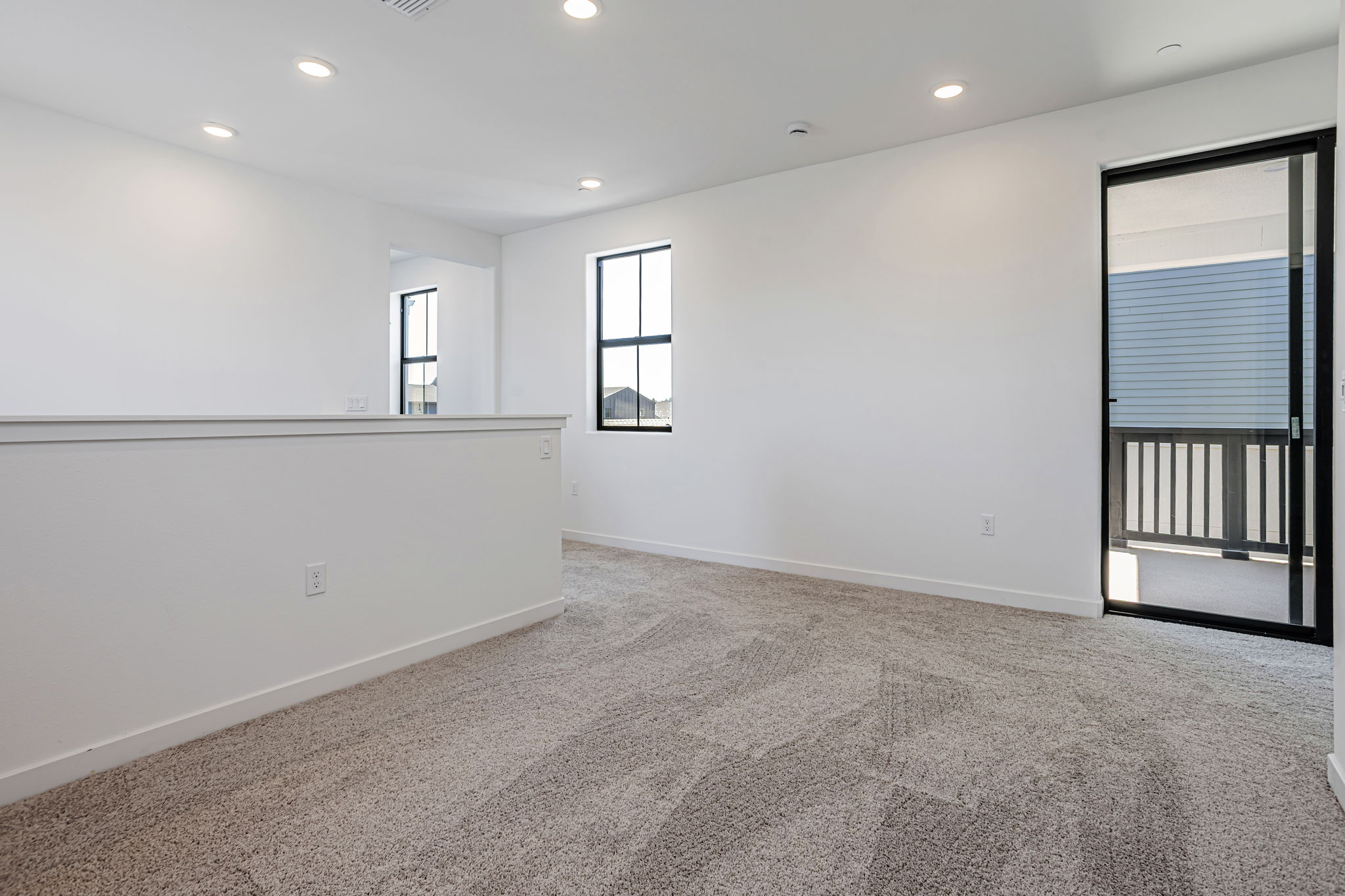 A room with a carpet and windows.