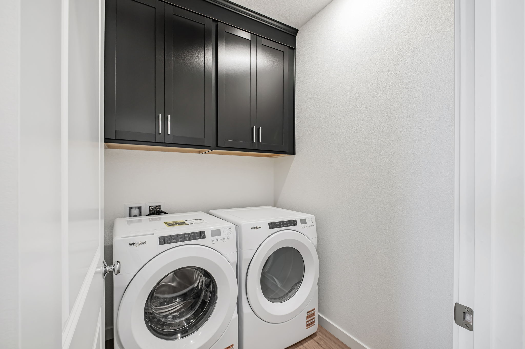 A washing machine and dryer in a room.