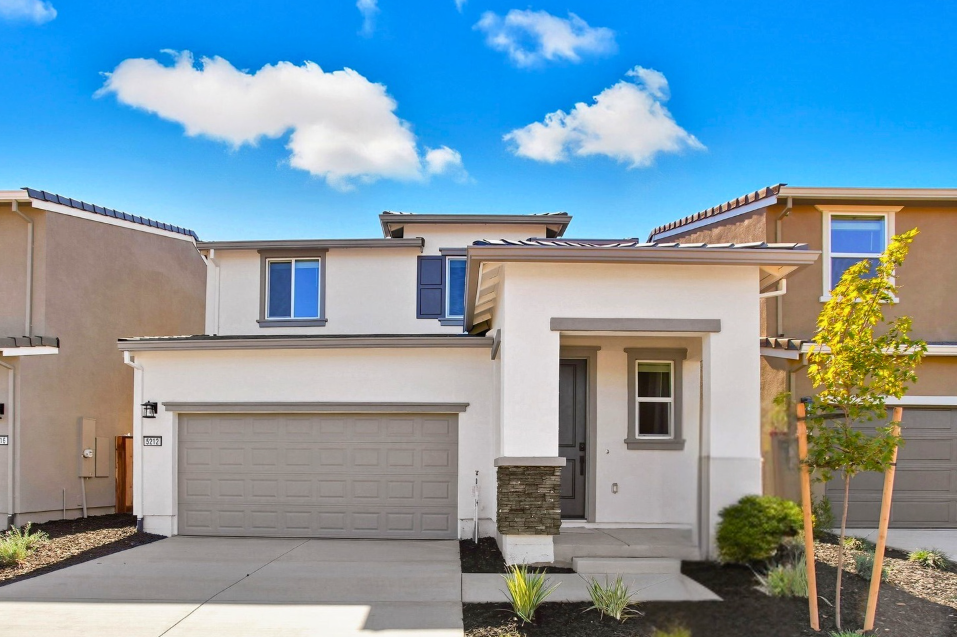 A house with garages and trees.